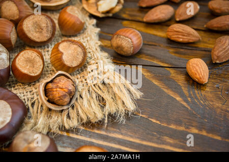 Mix of different nuts on a rustic background. Close-up photo with copy space. Healthy nutrition concept. Stock Photo