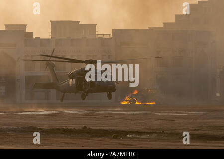 Military combat and war with helicopter landing in the chaos and destruction. Smoke and fire on the ground. Military concept of power, force, strength Stock Photo