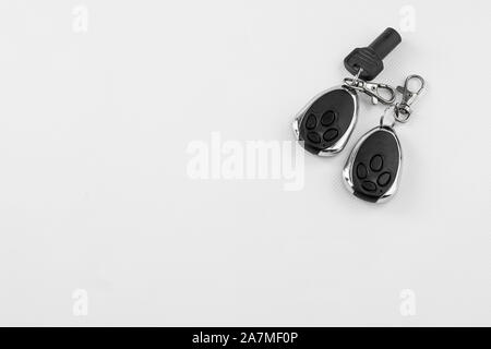 electronic keys by radiofrequency in key fobs for automatic opening of garage doors and alarm, in different biotons, with carabiners for anchoring and Stock Photo