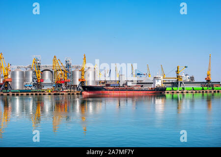 Old ship is in a cargo port on the sea Stock Photo