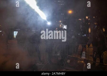 Hong Kong, China. 02nd Nov, 2019. A group of riot police use a flashlight at the middle of a cloud of smoke during the clashesHong Kong protesters demonstrate for 22nd consecutive weekend in Central district of Hong Kong. Protesters continue to call for Hong Kong's Chief Executive Carrie Lam to meet their remaining demands since the controversial extradition bill was withdrawn, which includes an independent inquiry into police brutality, the retraction of the word "riot" to describe the rallies, and genuine universal suffrage. Credit: SOPA Images Limited/Ģ����ý Live News Stock Photo