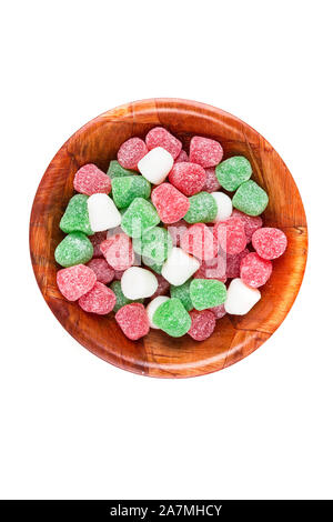 Red and white candy shaped Christmas ornaments decorating a green fir ...