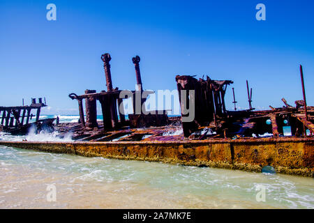 Photograph of the shipwreck of the SS Maheno on Fraser Island with a cloudless sky in the background. Fraser Island is located off Queensland in easte Stock Photo