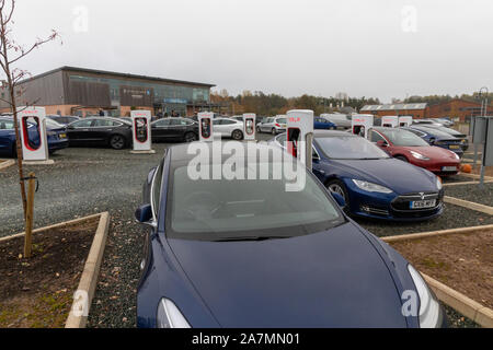 Tesla Cars charging at Darts Farm Superchargers, Exeter, Devon