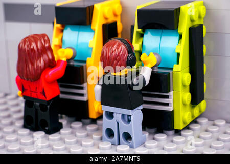 Tambov, Russian Federation - October 30, 2019 Lego boy and girl playing slot machines. Stock Photo