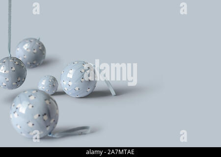 Blue pastel Christmas decoration balls on pink background. Minimal New year concept with creative copy space. Stock Photo