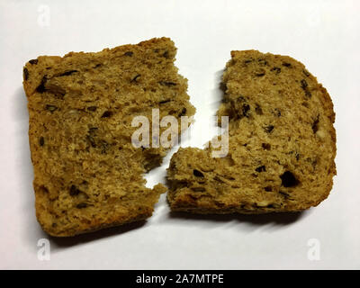 The photo shows slice toast, homemade bread with caraway isolated closeup in white background. Bread photos consisting of cut brown bakery products, r Stock Photo