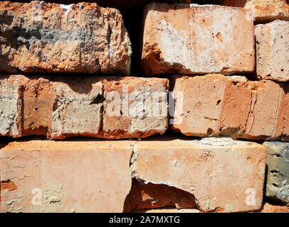 Texture brick, yellow color, background stone, structure lined with granite walls, sandstone on background bricks wall. Facing stones for decor house. Stock Photo
