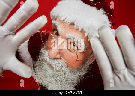 High angle portrait of classic Santa Claus looking close at camera and smiling cheerfully, copy space Stock Photo