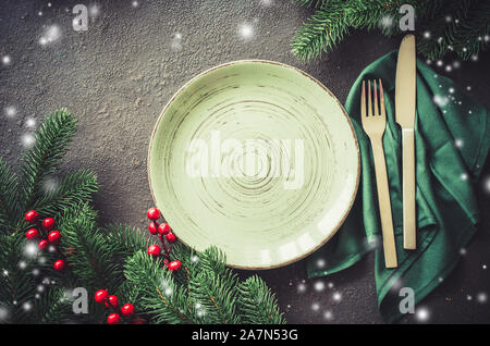 Christmas festive table setting with xmas decorations. Christmas background for writing the menu. Stock Photo