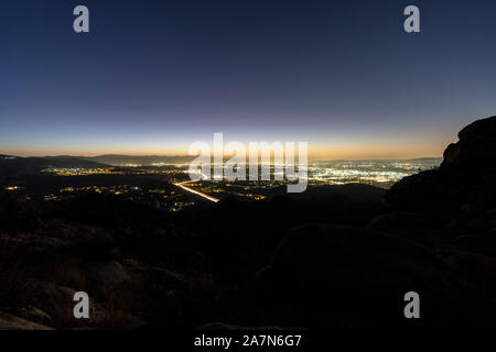 Glowing lights of Los Angeles California.  Viewed from Rocky Peak Mountain Park in Ventura County. Stock Photo