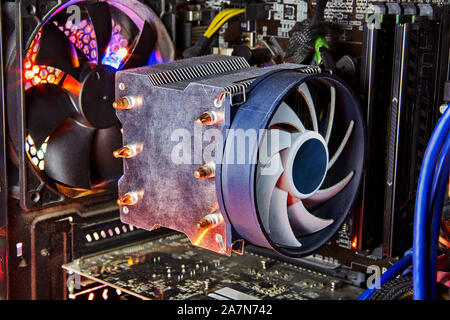 Heatsink and fan of central processing or the CPU cooler inside pc system unit. Cooling is required to remove the waste heat produced by computer comp Stock Photo