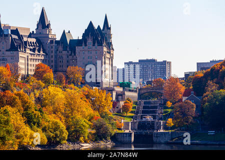 The Fairmont Château Laurier hotel, seen here from across the Ottawa River, stands on a hill next to locks connecting the Rideau Canal to the river. Stock Photo