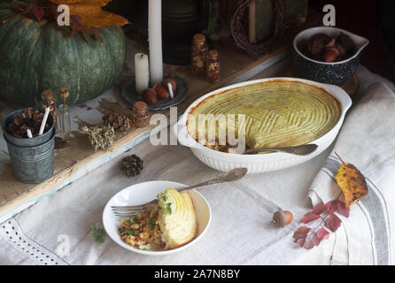 Rustic pie stuffed with minced chicken and cauliflower, and autumn still life on a wooden background. Rustic style. Stock Photo