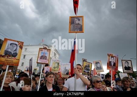 Orel, Russia, May 09, 2019: Victory Day, Immortal Regiment parade. Crowd with portraits of Stalin and their ancestors against cloudy gray sky backgrou Stock Photo