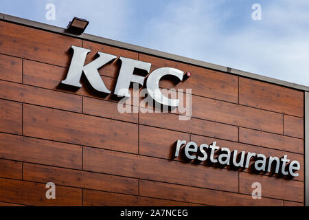 Coina, Portugal. KFC lettering on the facade of a Kentuky Fried Chicken fast food restaurant. Junk food restaurant in Barreiro Planet Retail Park. Stock Photo