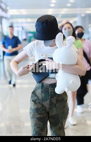 Chinese actress Zhang Xueying, also known as Sophie Zhang, arrives at the Shanghai Hongqiao International Airport before departure in Shanghai, China, Stock Photo