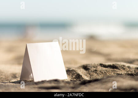 Black sticky notes on a beach Stock Photo