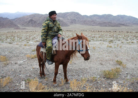 Sheepherder on horseback in Kyrgyzstan Stock Photo