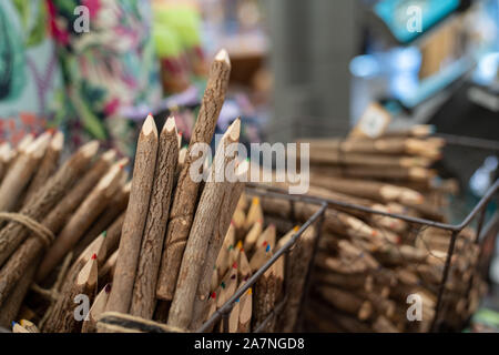 Color pencils styled as rustic wood sitting in baskets for sale Stock Photo