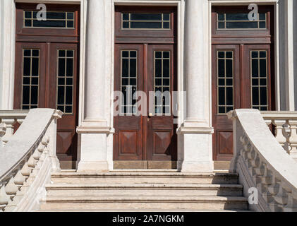 Outdoor staircase leading to large wooden double doors in classic setting Stock Photo