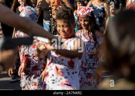 Kids participating in the Halloween walk of zombies advancing on the Day of the Dead, Finados, in Copacabana boulevard Stock Photo