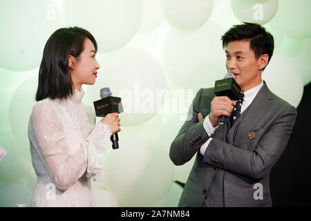 Chinese singer and actress Victoria Song or Song Qian, left, and actor Zhou Yiwei attend a promotional event for Hennessy in Hangzhou city, east China Stock Photo