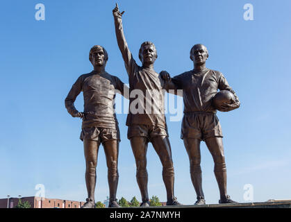 The United Trinity statue at entrance to Manchester United Old Trafford football ground, Trafford, Greater Manchester, England, United Kingdom