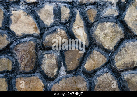 Close-up colored hand painted stone wall fence Stock Photo