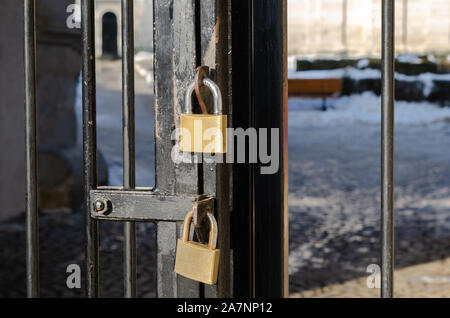 Close-up of two rusty locked padlock on metal door Stock Photo
