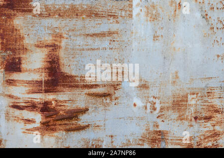 Old rusty piece of banner .Textured empty abandoned street advertising panel with white peeling paint Stock Photo