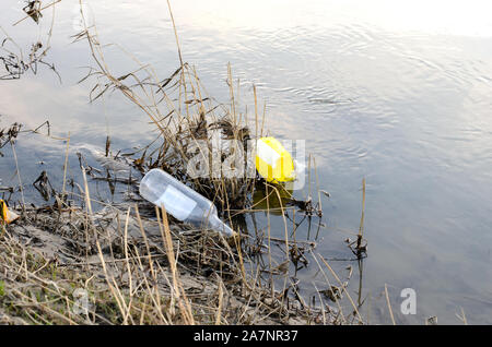 Abandoned plastic bag and bottle garbage at the lakeshore Stock Photo