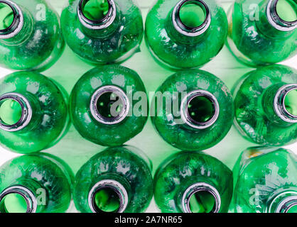 Overhead close up  of green  plastic  bottles without caps on table . Stock Photo