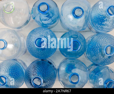 Full frame high angle view  shot of blue empty glass bottles on table . Stock Photo