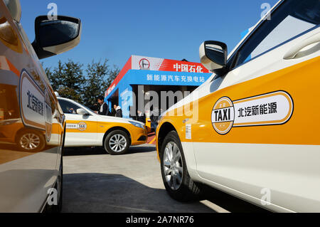 --FILE--The BAIC BJEV taxis are parked in a charging station in Beijing, China, 29 October 2016.   Beijing plans to have around 20,000 electric taxis Stock Photo