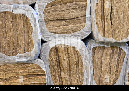 Pile of   round basalt mineral wool packages  in plastic foil . Stock Photo