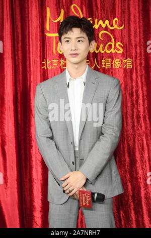 Chinese actor Bai Jingting attends an unveiling ceremony for his own wax figure at the Madame Tussauds museum in Beijing, China, 20 August 2019. Stock Photo