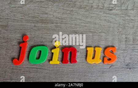 Join us   sentence written with  plastic letters on a wooden table . Looking for employees concept . Stock Photo