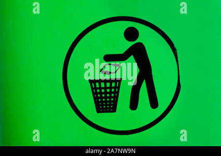 Throw the garbage into the basket-  sign on  green   background. Stock Photo