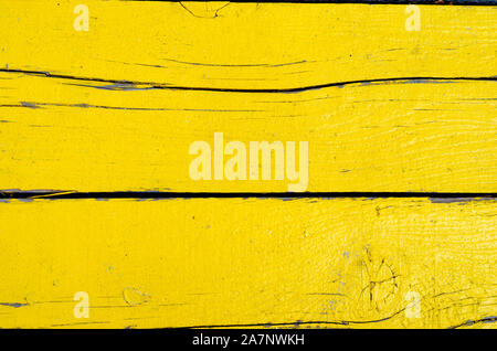 Full frame shot of rusty   yellow painted wooden timber  wall . Stock Photo
