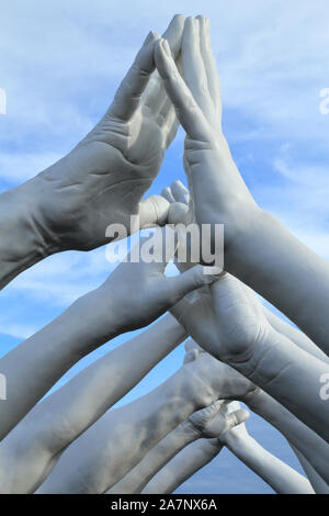 Art Biennale Venice 2019. Giant joined hands sculpture 'Building Bridges' by Lorenzo Quinn. Exhibition at Arsenale, Castello, Venice. Stock Photo