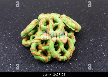 Brown and green caramel apple pretzel treats Stock Photo