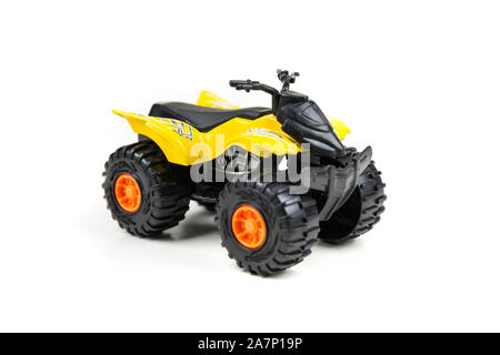 Yellow toy plastic quad atv on a white background Stock Photo