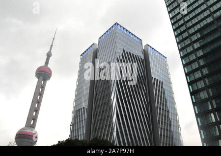 --FILE--The Foxconn headquarters building is under construction along the Oriental Pearl TV Tower in Pudong, Shanghai, China, 2 December 2018.   Tech Stock Photo