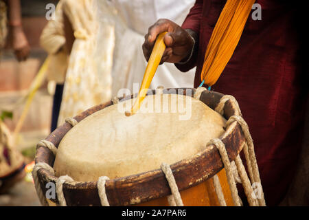Close up of Hands performing Indian art form Chanda or chande cylindrical percussion drums playing during ceremony Stock Photo