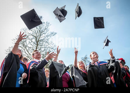 Traditional post-ceremony throwing of mortarboard caps during graduation ceremony day at St. Mary’s University, Twickenham, UK. Stock Photo