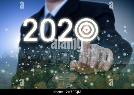 Finger of businessman clicking on target of 2020 concept. Stock Photo