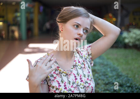 Young caucasian woman girl on a hot sunny day suffers from the heat stroke Stock Photo