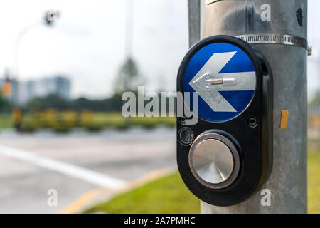 Traffic light pedestrian button, background blurred. Stock Photo