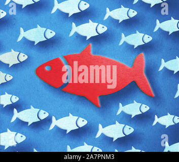 Red big fish swimming through the opposite direction. 3D illustration. Stock Photo